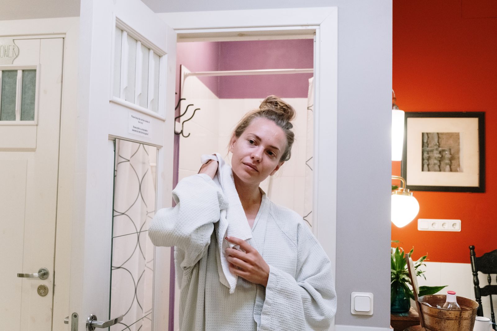 Person in a bathrobe completing an after-shower bathroom reset
