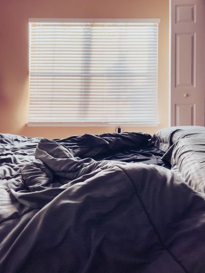 Unmade bed ready for a planned sheet-changing routine