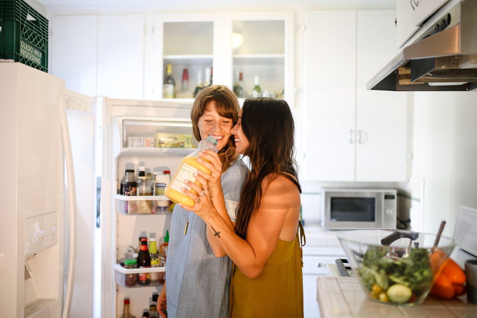 Couple talking together beside their refrigerator