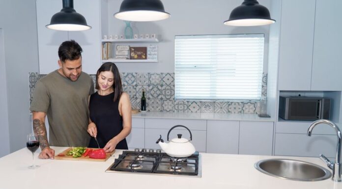 When Your Partner Leaves Food Splattered in the Microwave: A Shared Cleanup Rule Couple cooking together while sharing responsibility for kitchen cleanup