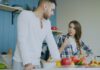 Couple calmly discussing a shared bathroom routine at home