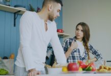 Couple calmly discussing a shared bathroom routine at home