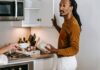Couple discussing empty food containers and kitchen restocking
