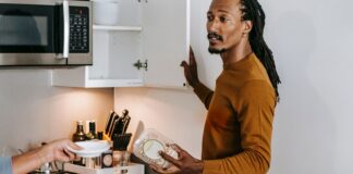 Couple discussing empty food containers and kitchen restocking