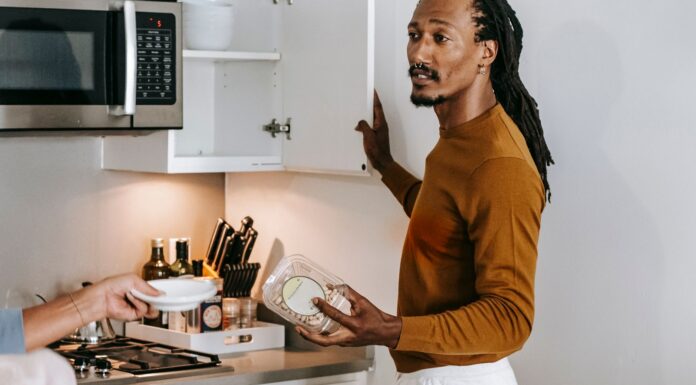 Couple discussing empty food containers and kitchen restocking