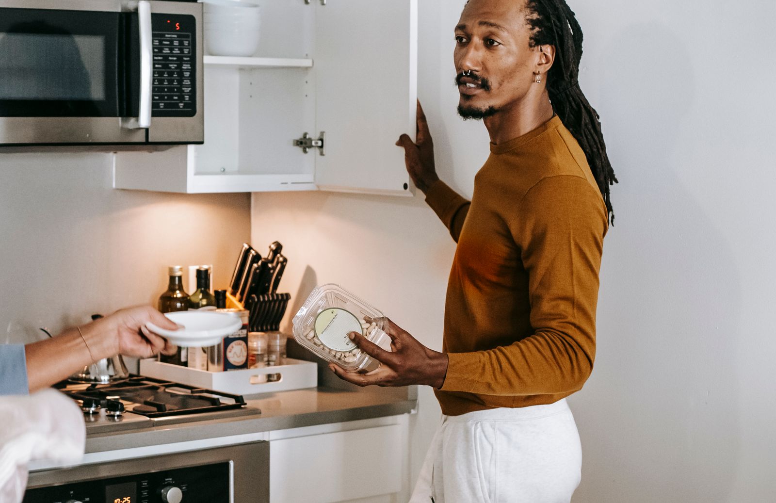 Couple discussing empty food containers and kitchen restocking
