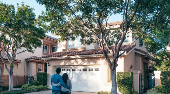 Couple outside their home discussing a garage closing routine