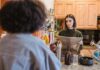 Couple discussing a paper towel restocking routine in their kitchen
