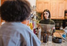 Couple discussing a paper towel restocking routine in their kitchen
