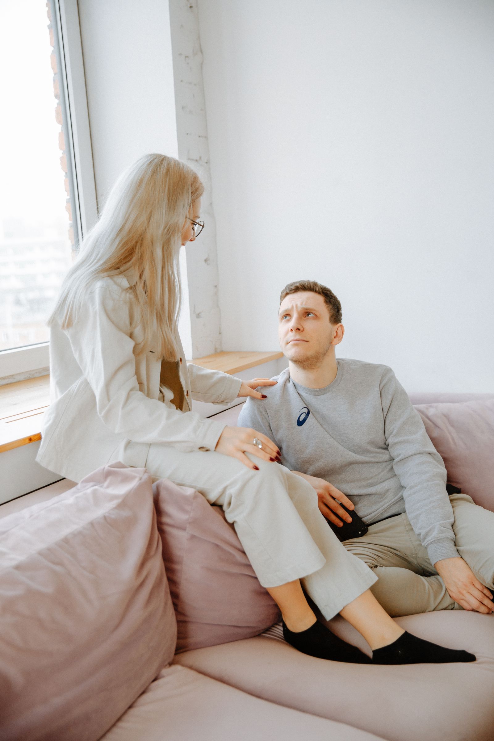 Couple discussing a shared shoe storage routine at home