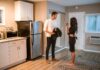 Couple discussing their shared water pitcher routine in the kitchen