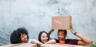 People organizing cardboard delivery boxes together in a shared home
