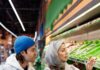 Couple shopping for groceries while planning food storage at home