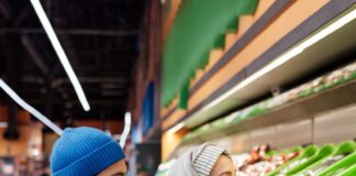 Couple shopping for groceries while planning food storage at home
