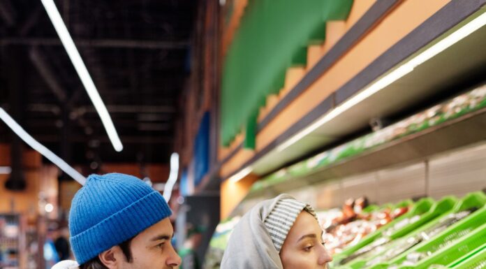 Couple shopping for groceries while planning food storage at home