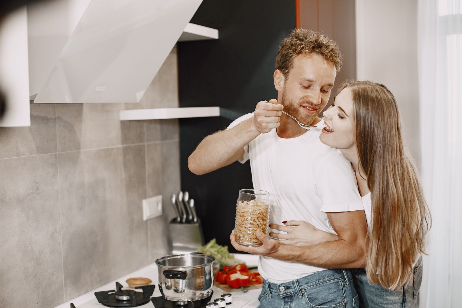 Couple talking together while standing in their kitchen