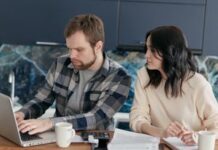 Couple reviewing plans together on a laptop at home