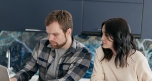 Couple reviewing plans together on a laptop at home