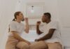 Couple sharing a bathroom while discussing their cleanup routine
