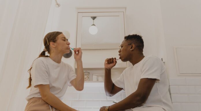 When Your Partner Leaves Hair in the Shower Drain: How to Share Bathroom Cleanup Without Nagging Couple sharing a bathroom while discussing their cleanup routine