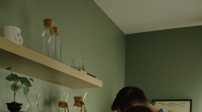 When Your Partner Leaves Used Coffee Grounds in the Coffee Maker: A Simple Cleanup Rule Couple making coffee together beside a coffee machine in their kitchen