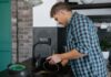 When Your Partner Never Unloads the Dishwasher: How to Agree on a Clear Handoff Couple talking while sharing dishwashing chores in their kitchen