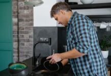 Couple talking while sharing dishwashing chores in their kitchen