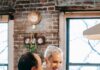 Couple cooking together beside a stovetop before sharing the kitchen cleanup