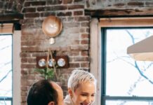 Couple cooking together beside a stovetop before sharing the kitchen cleanup