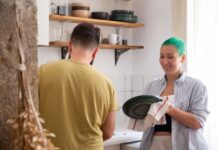 When Your Partner Leaves Dirty Dishes in the Sink: How to Share Cleanup Without Nagging Couple washing dirty dishes together in the kitchen
