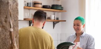 Couple washing dirty dishes together in the kitchen