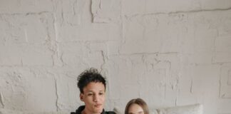 Couple relaxing on a sofa while watching television with a remote control