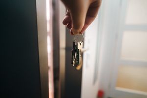 House keys held near a home entryway as part of a consistent arrival routine