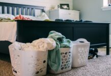 Laundry baskets beside a bed for an easy clothing routine