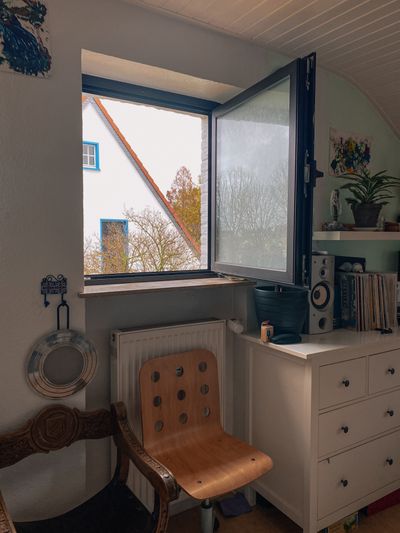Open window in a bright room that needs a final household check