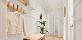 Organized shoe storage in a clear home hallway