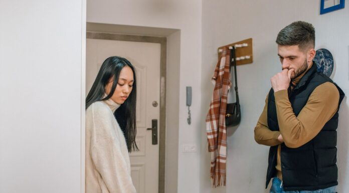 Couple addressing leaves laundry in the washer