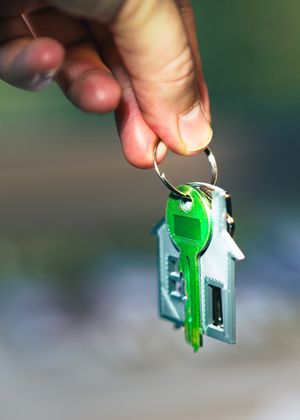 A separate house key held as a planned backup for a shared home