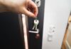 House keys held at a home doorway as part of a reliable daily routine