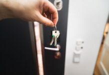 When Your Partner Keeps Misplacing Their Keys: How to Build a Reliable Exit Routine House keys held at a home doorway as part of a reliable daily routine