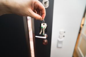 When Your Partner Keeps Misplacing Their Keys: How to Build a Reliable Exit Routine House keys held at a home doorway as part of a reliable daily routine