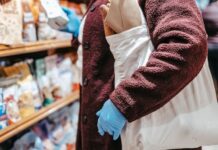 When Your Partner Forgets the Reusable Grocery Bags: How to Share the Shopping Setup Shopper using a reusable grocery bag while selecting food in a supermarket