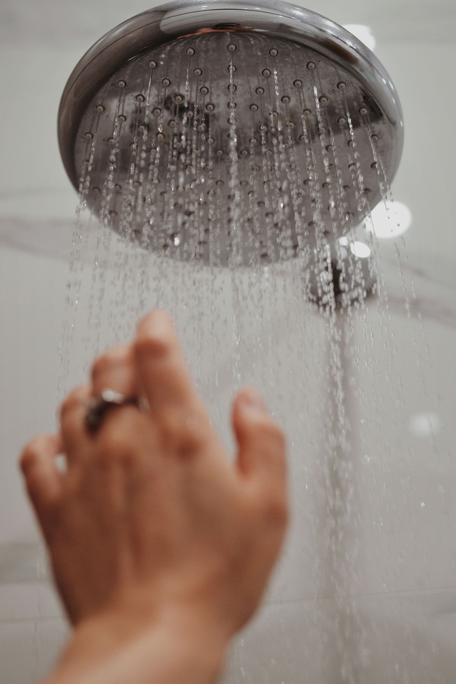 Running shower head during a household hot water routine