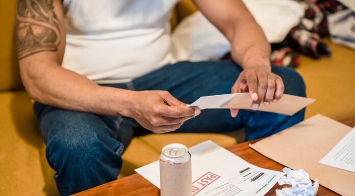 Person sorting household mail and papers while seated at home