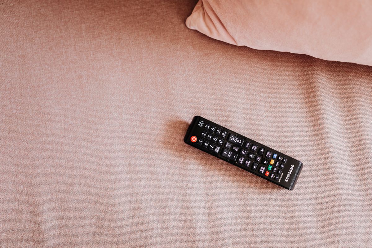 TV remote resting in a designated place on a living room sofa