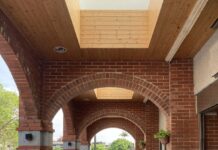 Ramp with handrails beneath a red brick archway in Taiwan