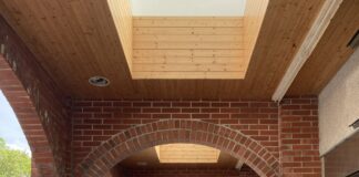 Ramp with handrails beneath a red brick archway in Taiwan