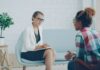 Changing Couples Therapists: How to Discuss Fit and Plan a Handoff Two adults speaking during a consultation in a modern counseling office
