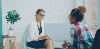 Two adults speaking during a consultation in a modern counseling office