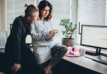 When Your Partner Volunteers Your Time Without Asking Two adults looking together at a device in a home office